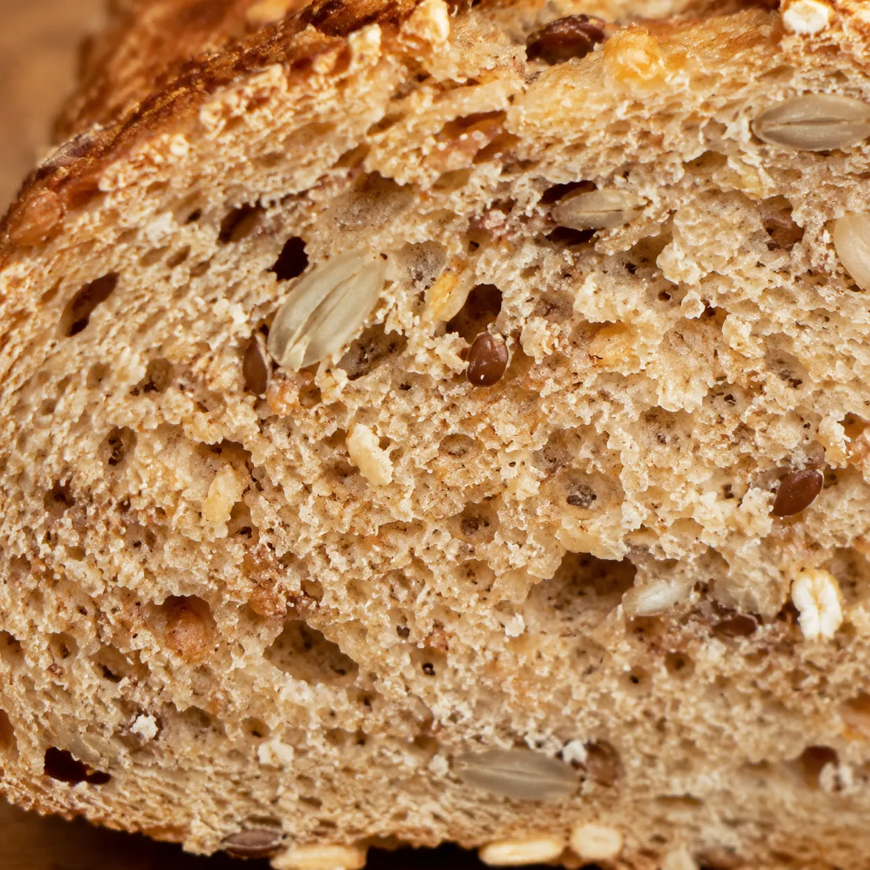 Close-up of whole grain bread crumb with seeds and oats