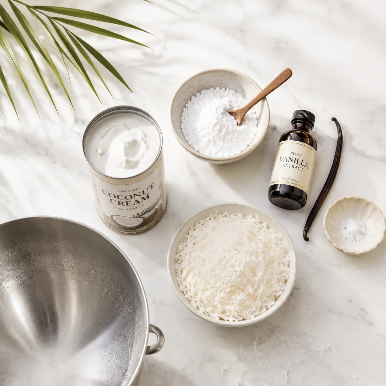 Coconut cream ingredients flatlay with vanilla, powdered sugar, and shredded coconut