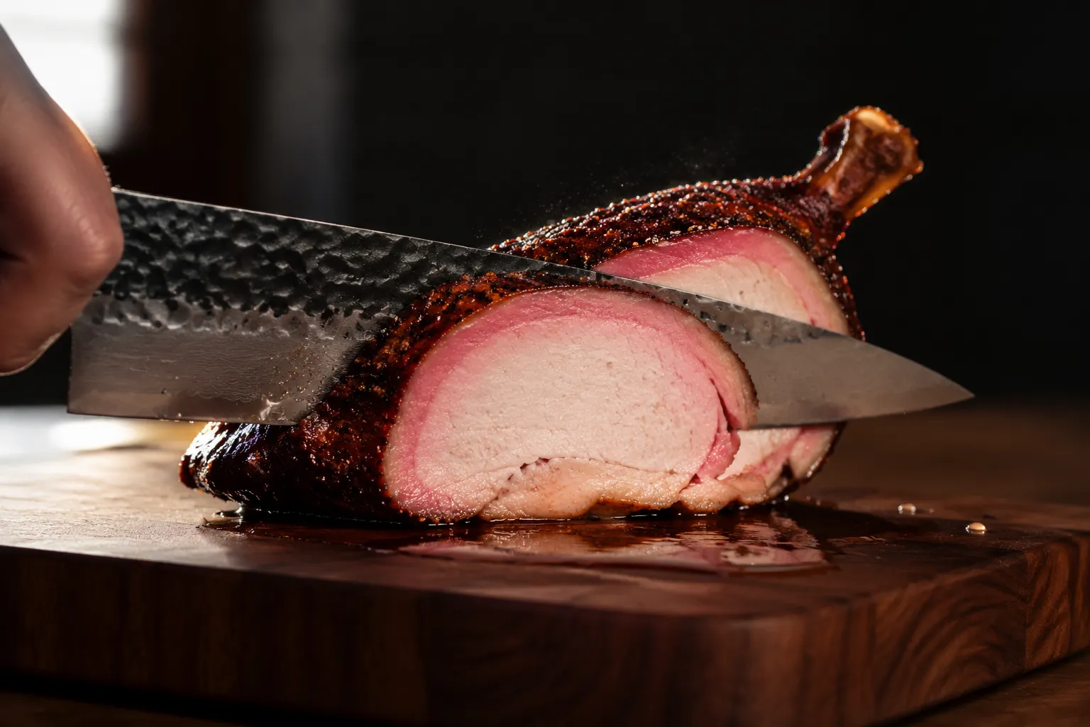 Slicing smoked chicken breast to show the pink smoke ring