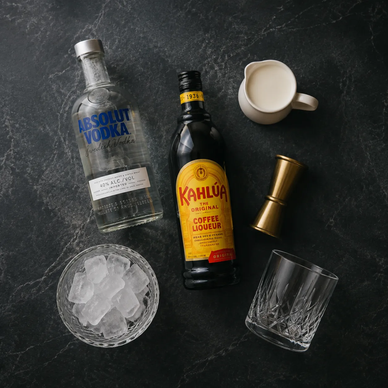 White Russian ingredients flatlay with vodka, Kahlúa, and heavy cream