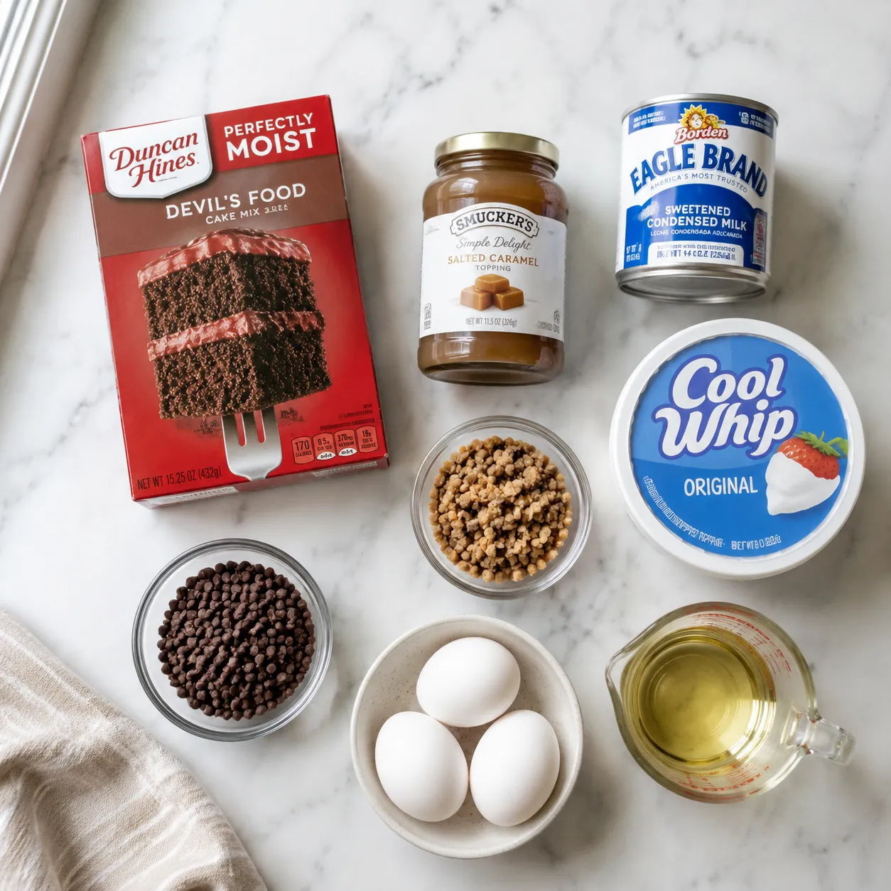 Better than sex cake ingredients flatlay with cake mix, caramel, and toffee bits