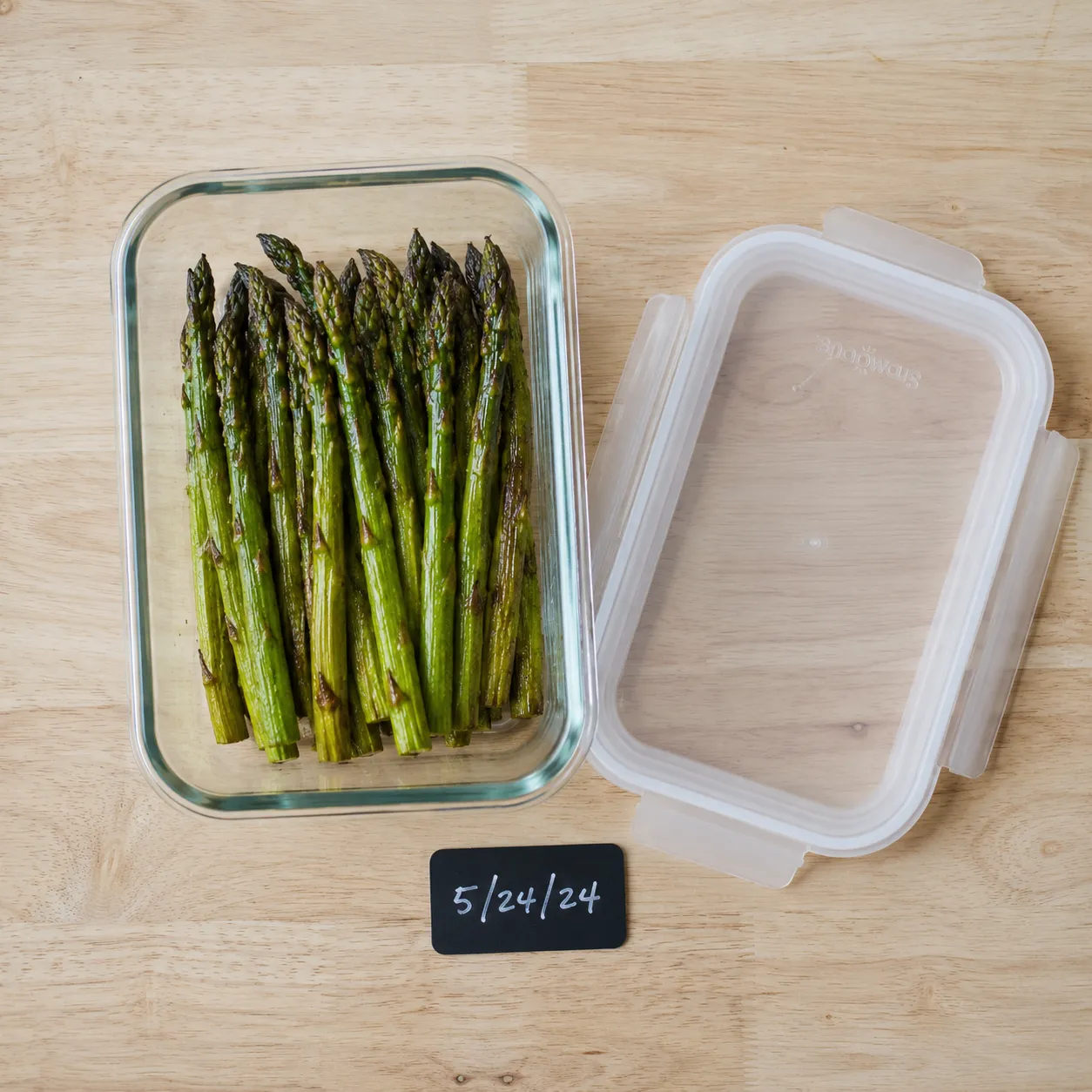 Leftover roasted asparagus in a glass meal prep container for storage