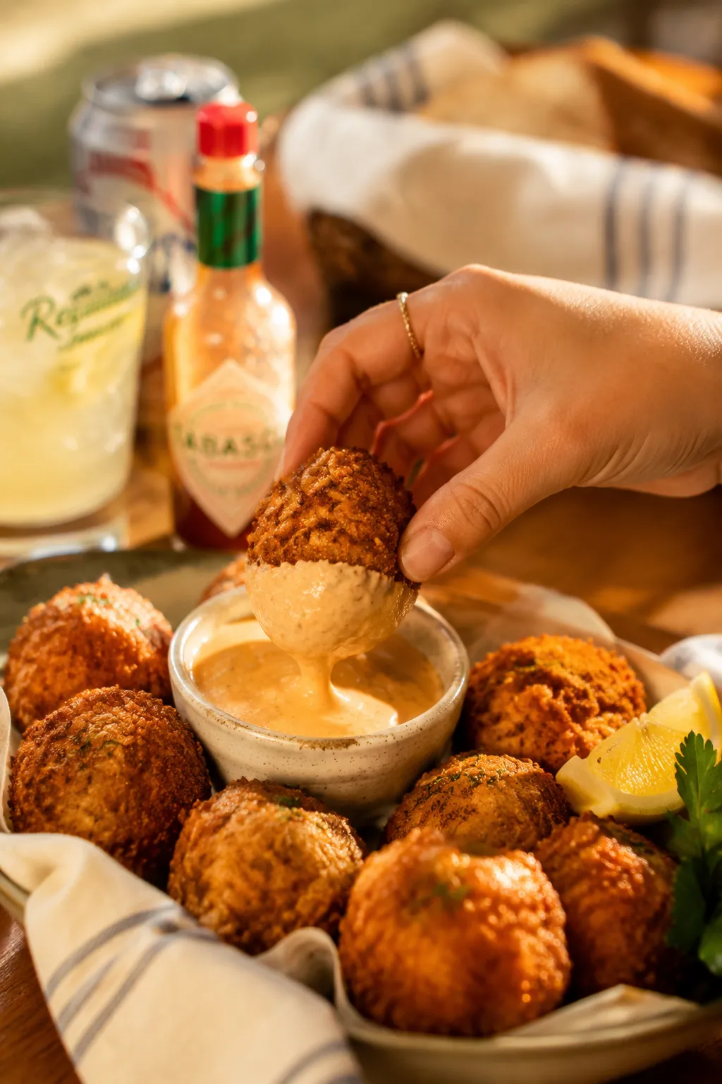 Dipping a boudin ball into Creole remoulade sauce