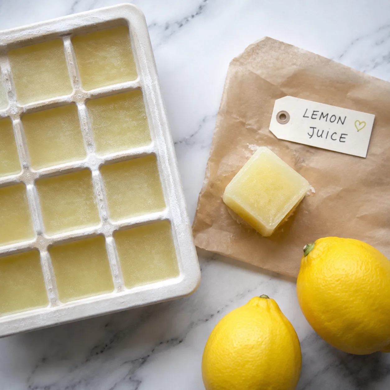 Freezing fresh lemon juice in ice cube trays for storage