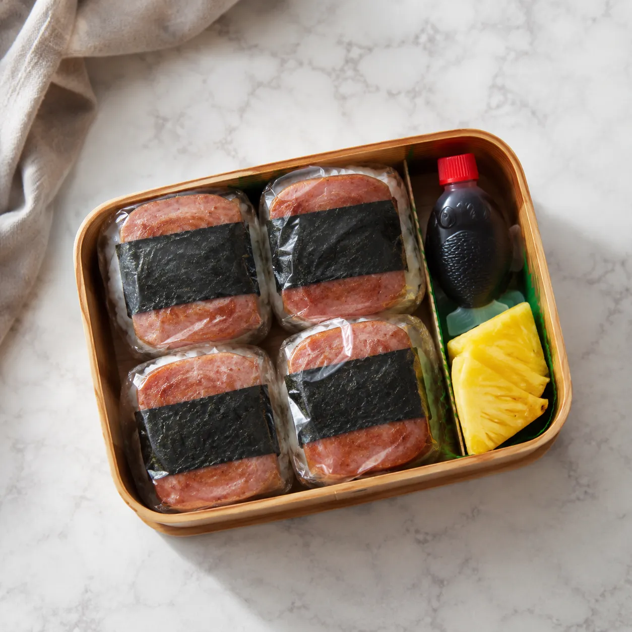 Wrapped spam musubi packed in a bento box for storage