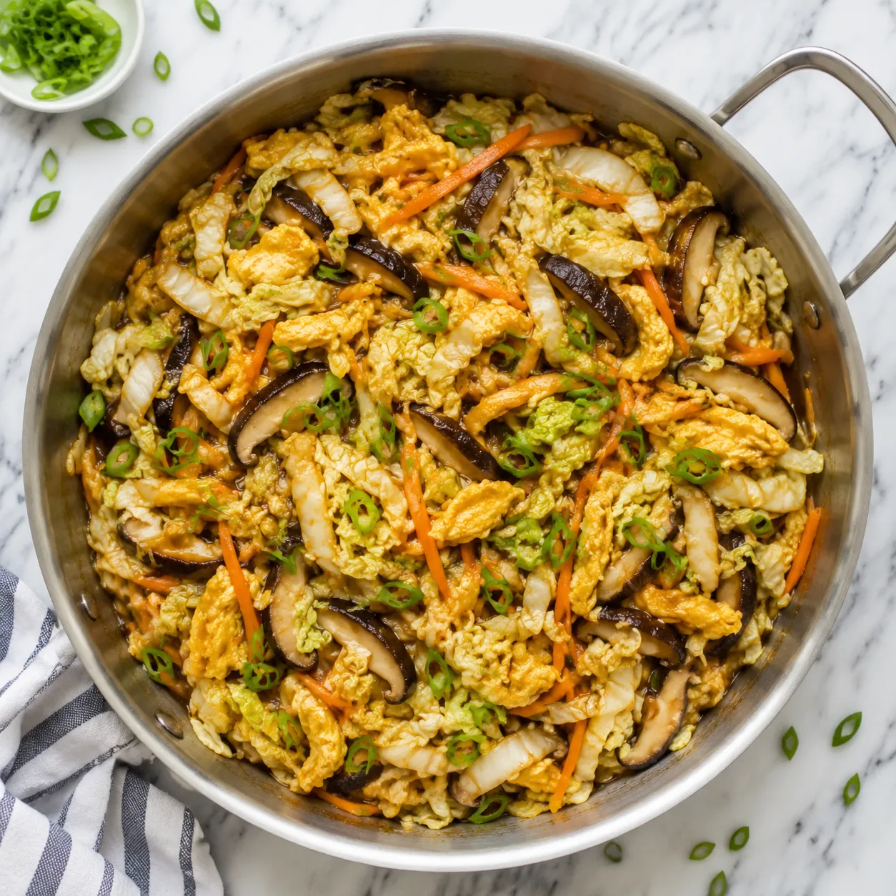 Stir-frying cabbage, shiitakes, and eggs for moo shu chicken filling