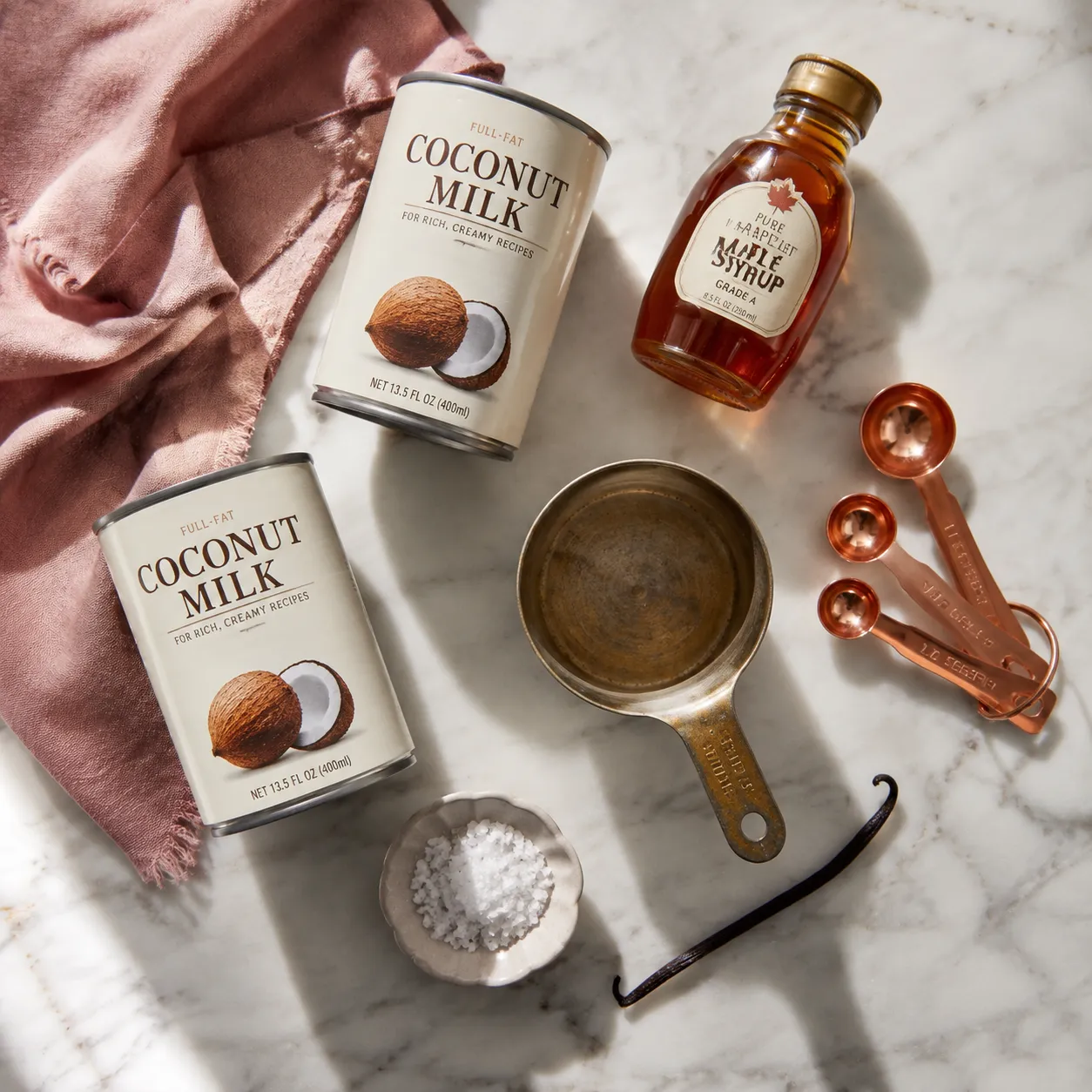 Plant based ice cream ingredients flatlay with coconut milk and maple syrup
