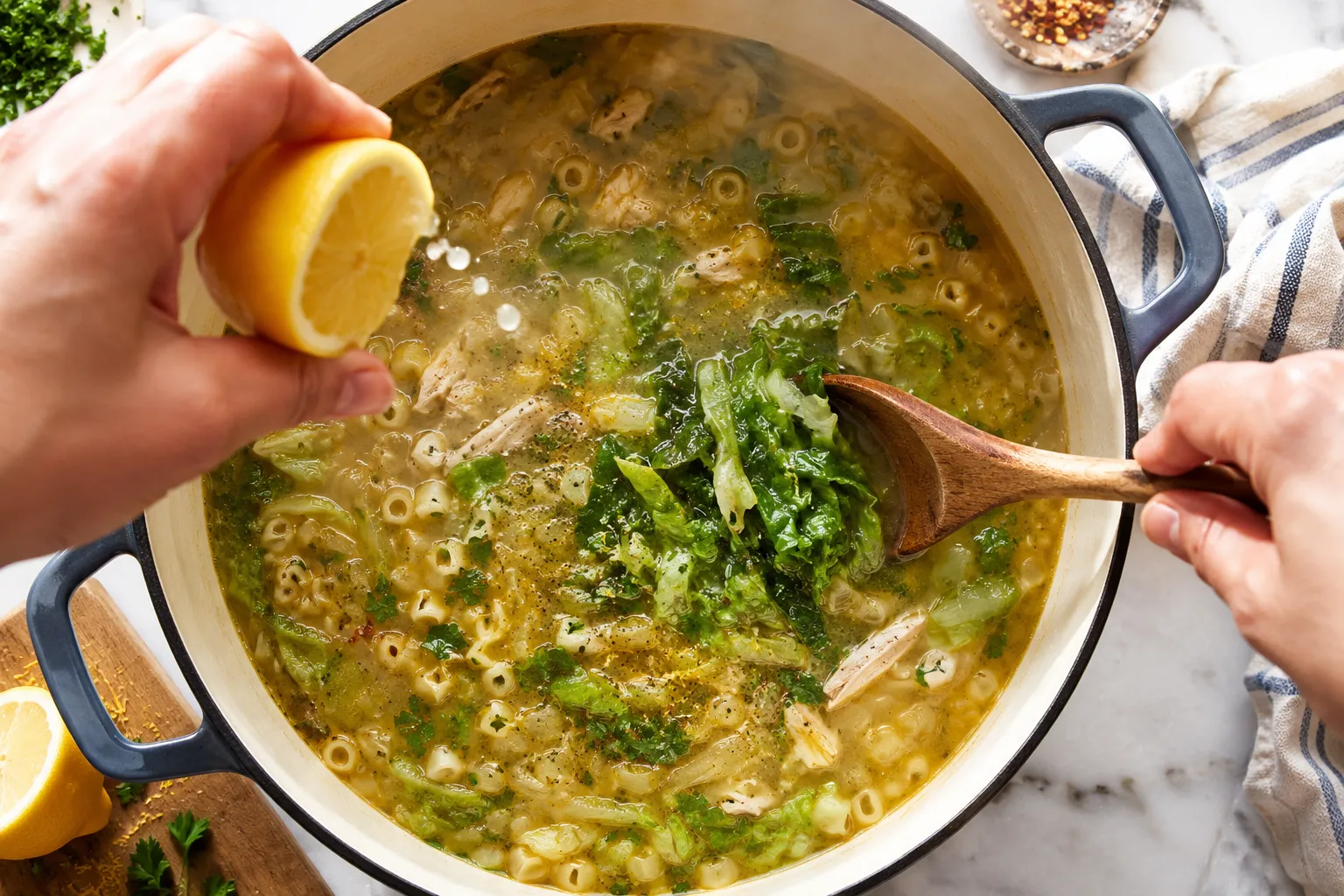 Stirring lemon juice and escarole into Italian penicillin soup
