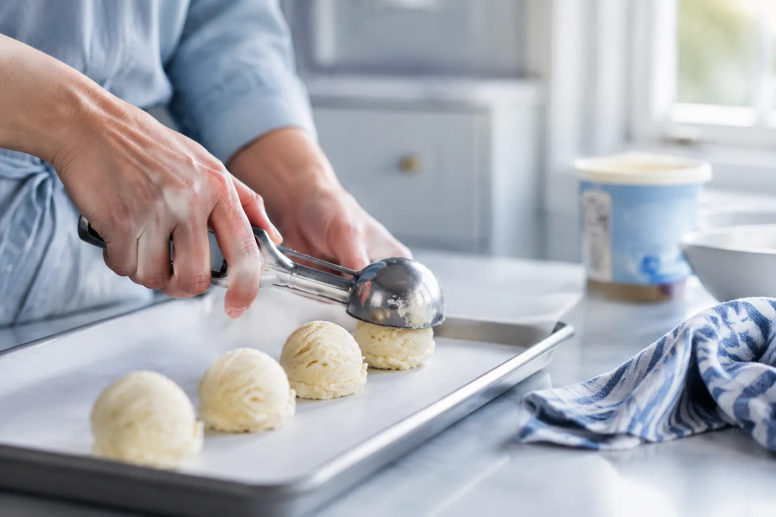 Scooping vanilla ice cream into balls before making fried ice cream