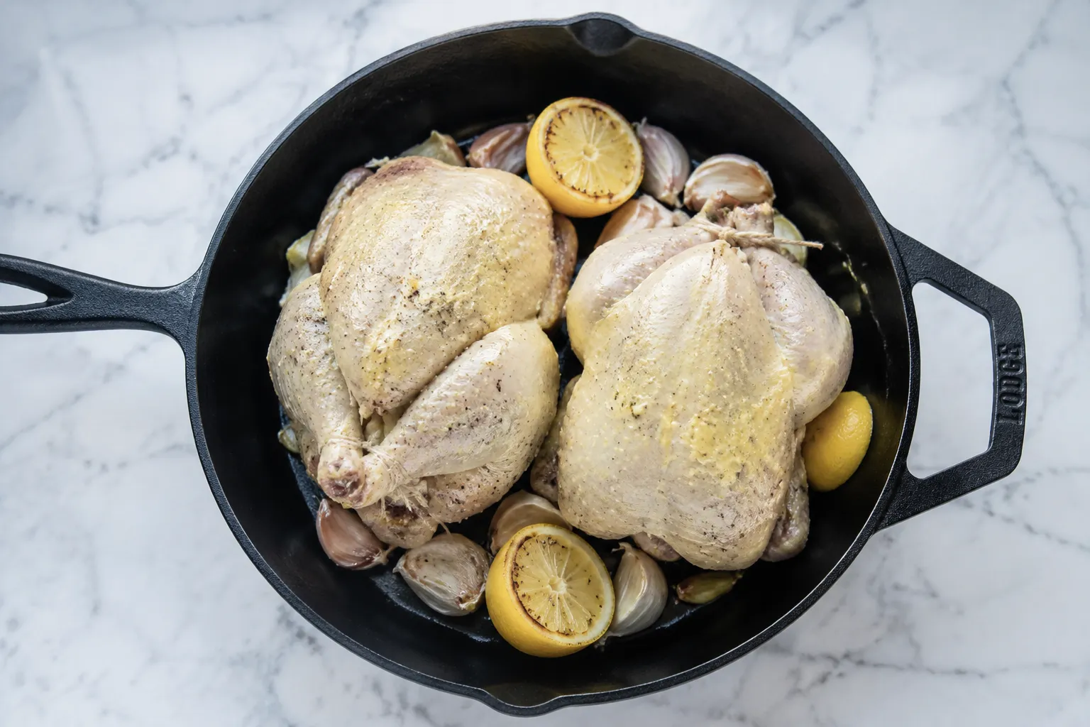 Trussed Cornish hens in skillet ready to roast