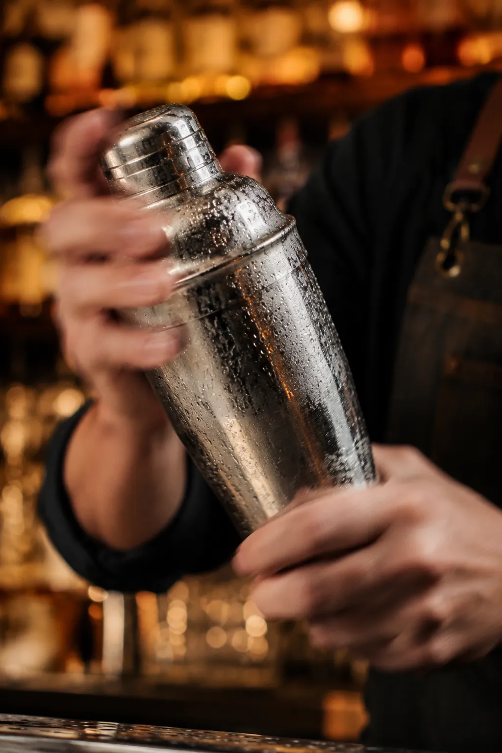 Shaking lemon drop shot cocktail in a frosty shaker
