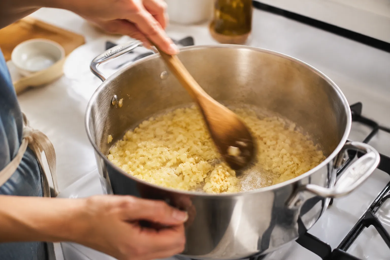 Sautéing onion and garlic in butter for chicken and noodles