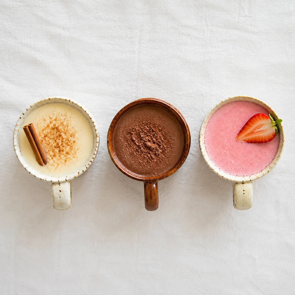 Three atole flavor variations: vanilla, champurrado, and strawberry