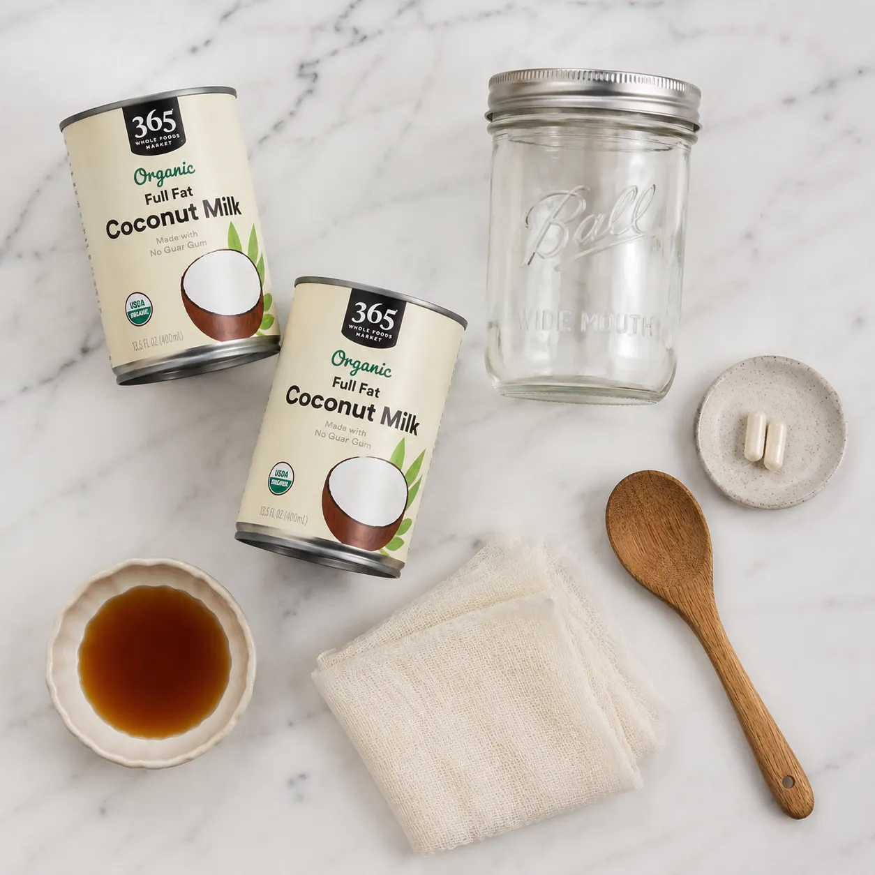 Coconut milk yogurt ingredients flatlay with probiotics and mason jar