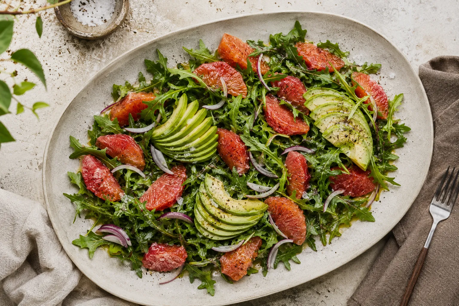 Finished cara cara orange and avocado salad on stoneware platter