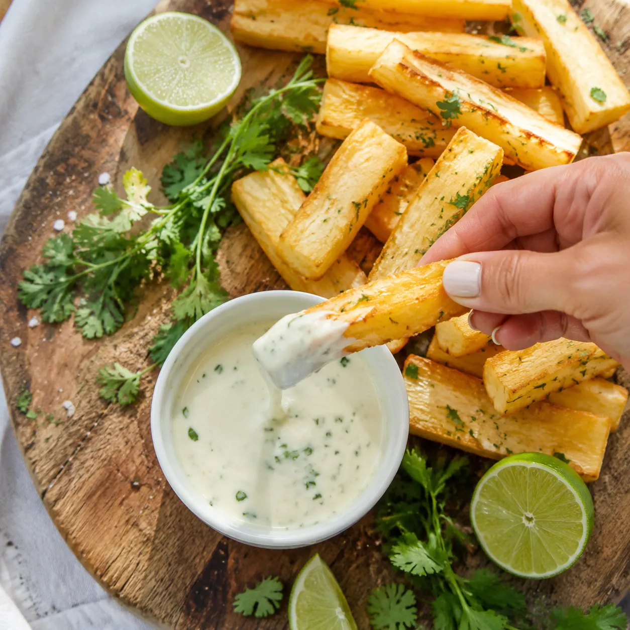 Dipping a yucca fry into garlic mojo sauce
