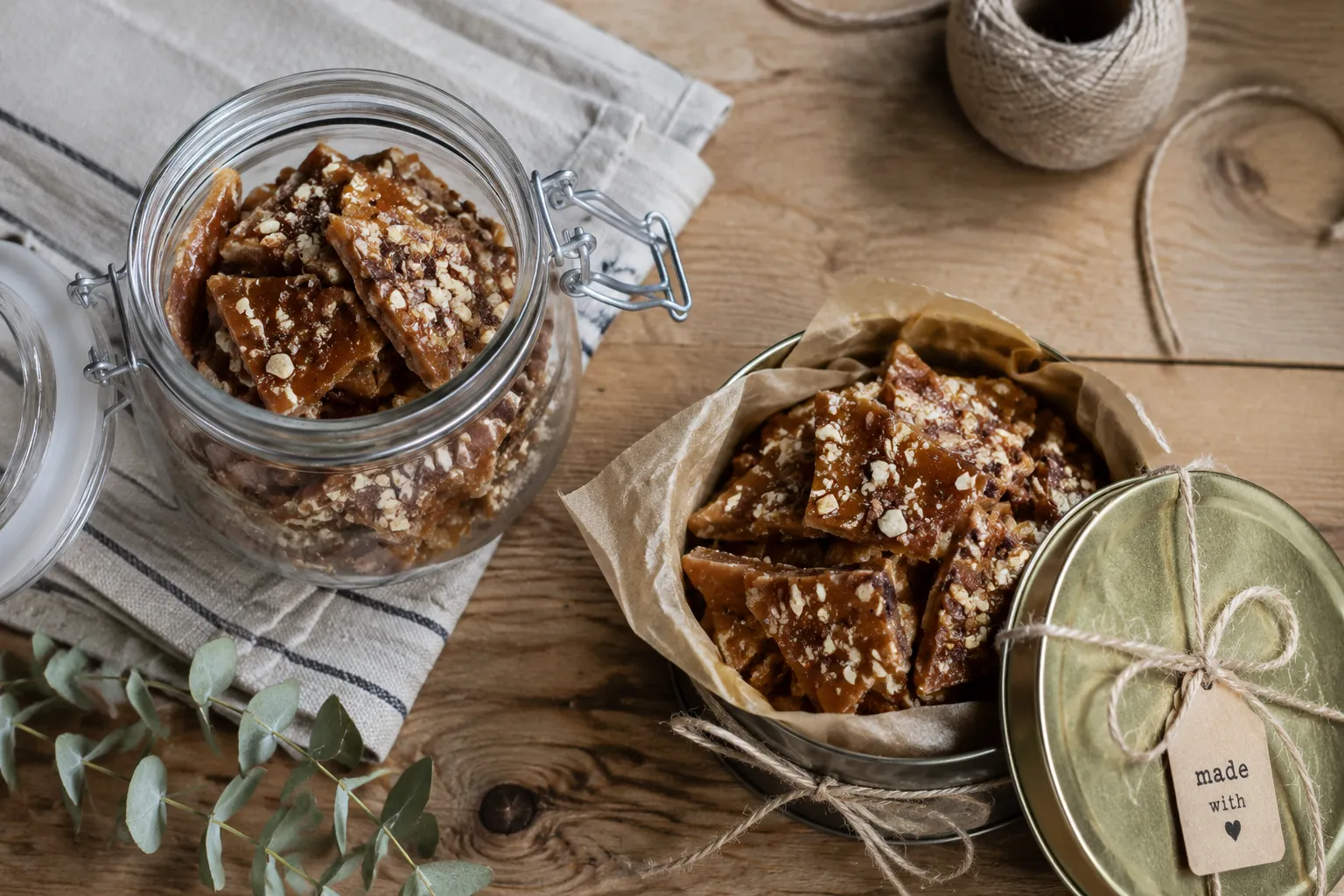 Storing homemade English toffee in a glass jar and gift tin