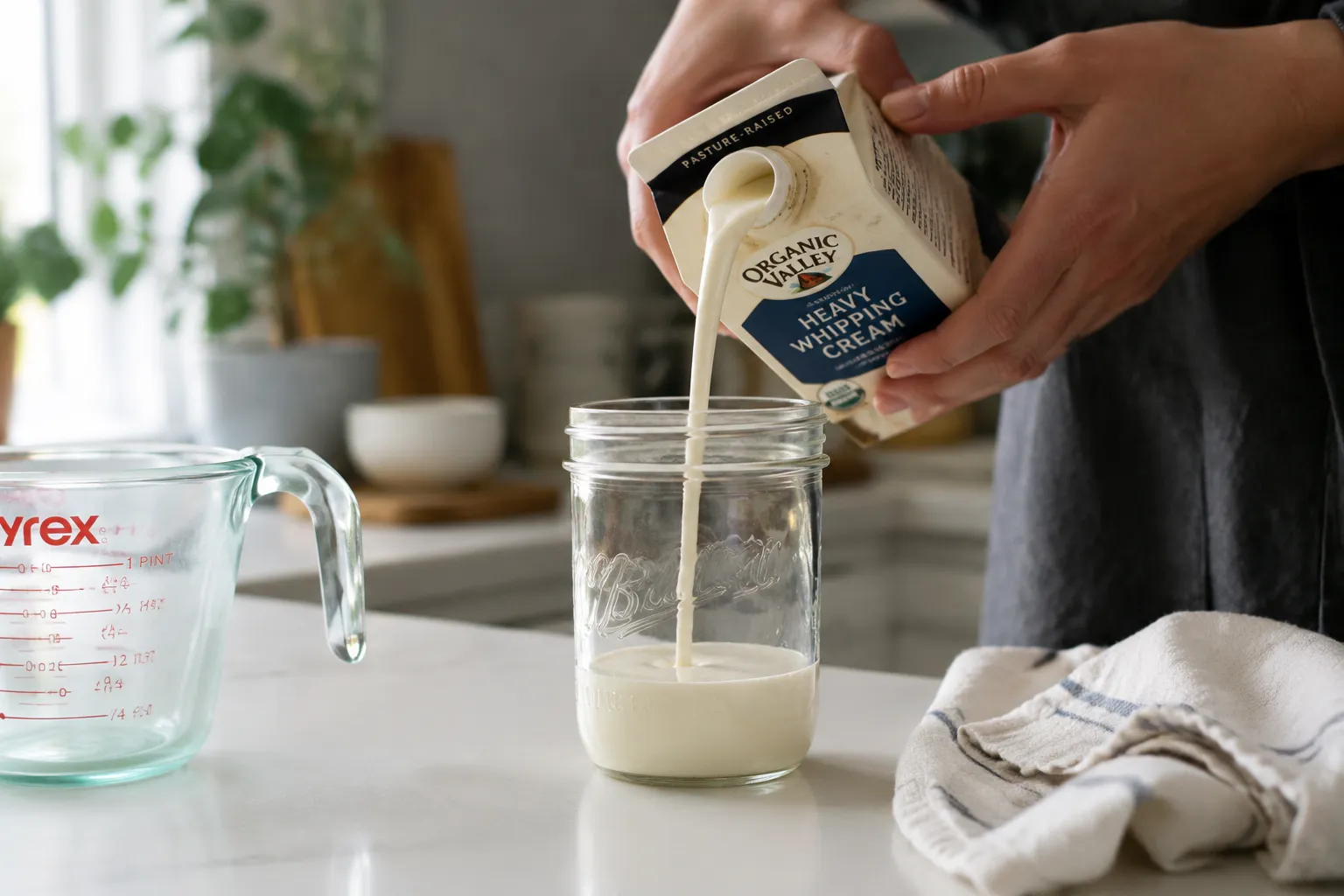 pouring heavy cream into a jar for homemade crème fraîche