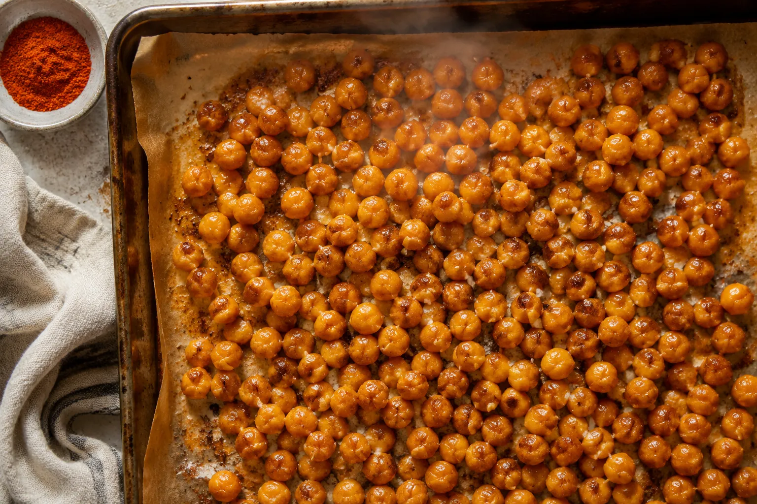 Finished oven-roasted chickpeas recipe golden brown on sheet pan