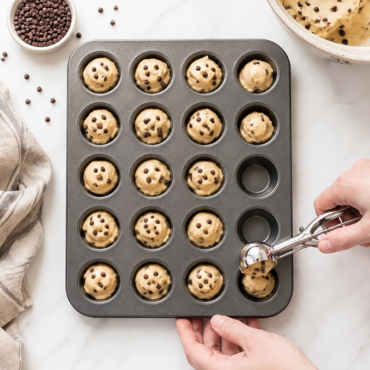 Filling mini muffin pan with batter using a cookie scoop