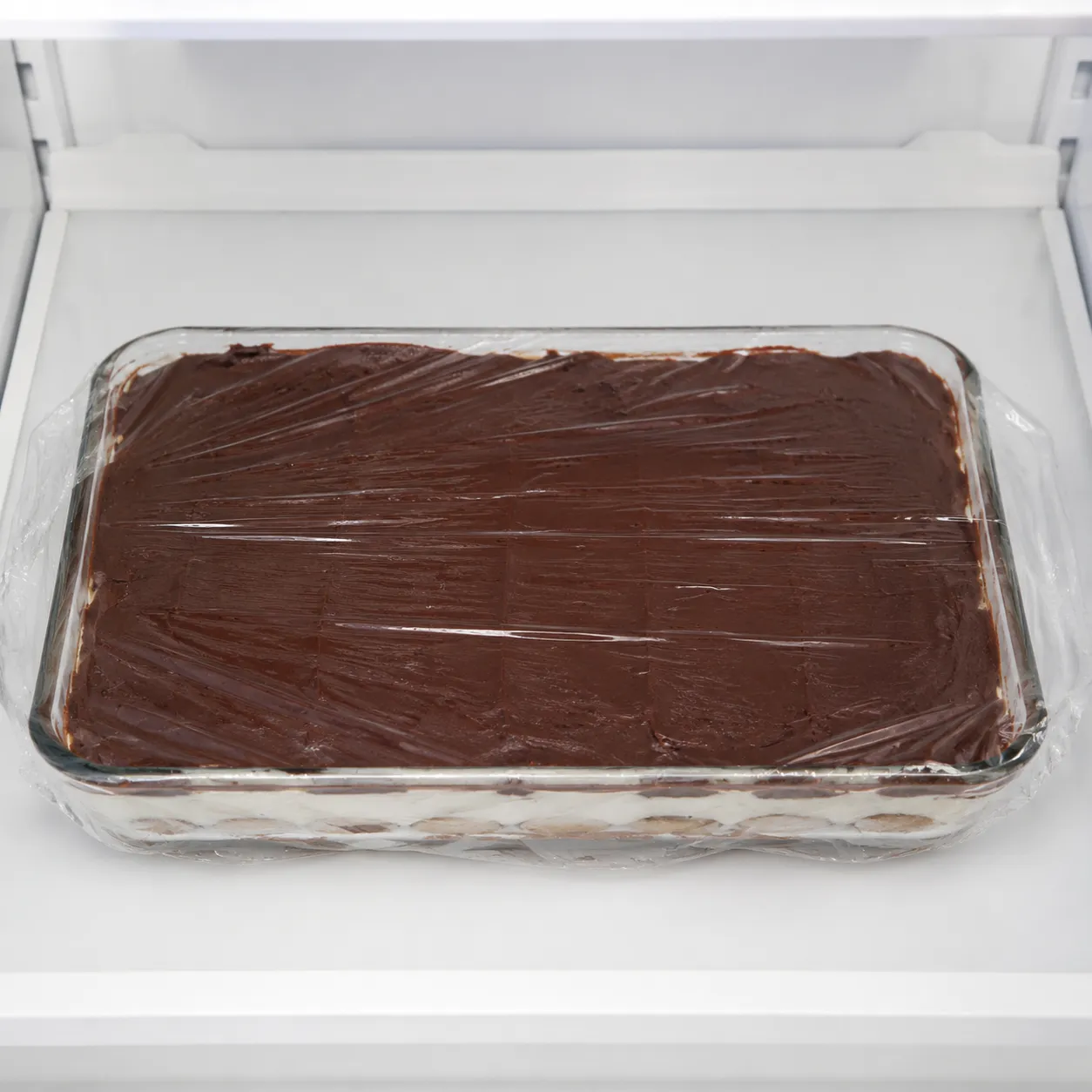 Storing chocolate eclair cake in the refrigerator overnight to chill