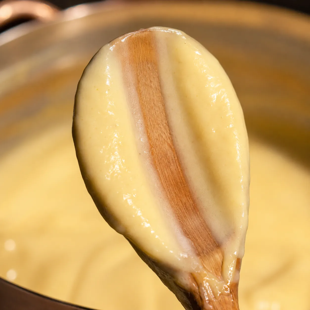 Custard coating the back of a spoon at proper thickness