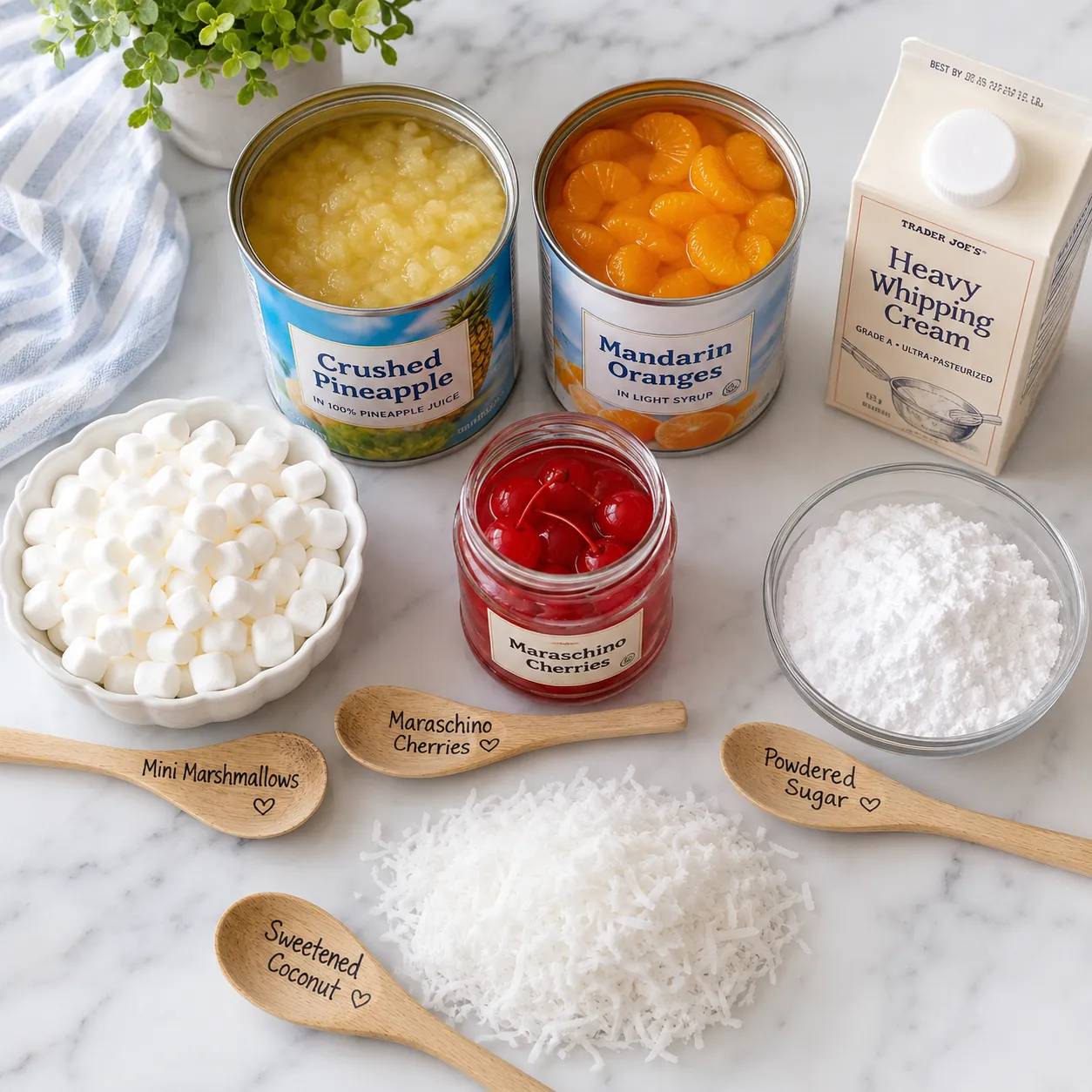 Ingredients for ambrosia salad recipe laid out on a marble counter.