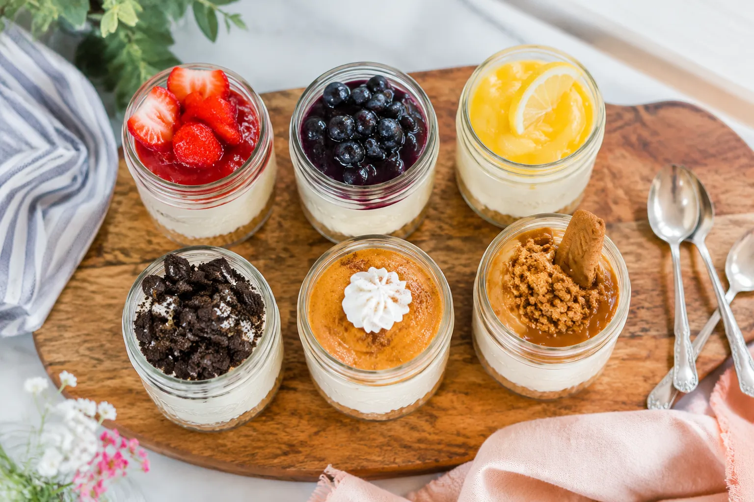 Mini no-bake cheesecake recipe variations in jars with different toppings