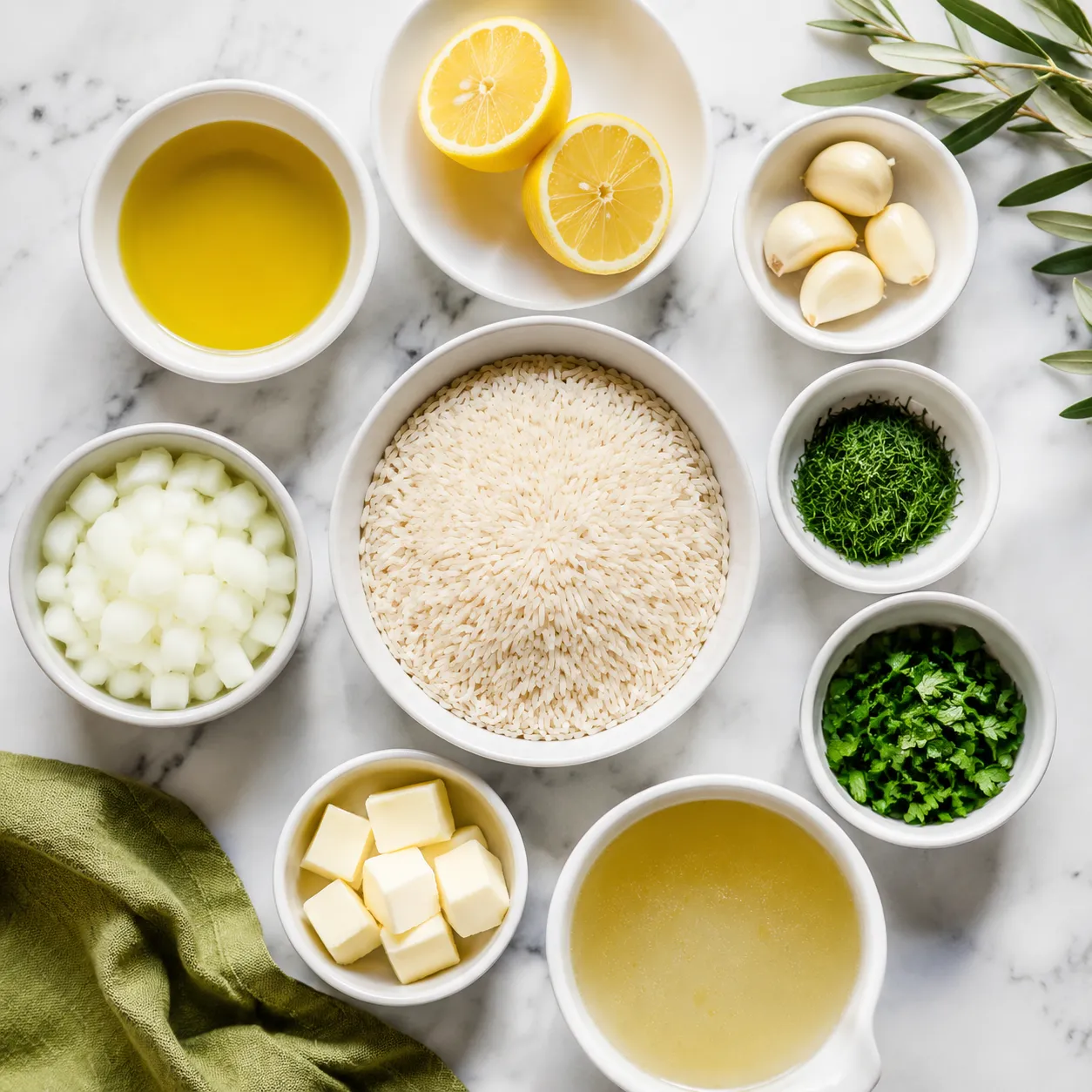 Greek rice ingredients flatlay with rice, lemons, garlic, dill, and olive oil