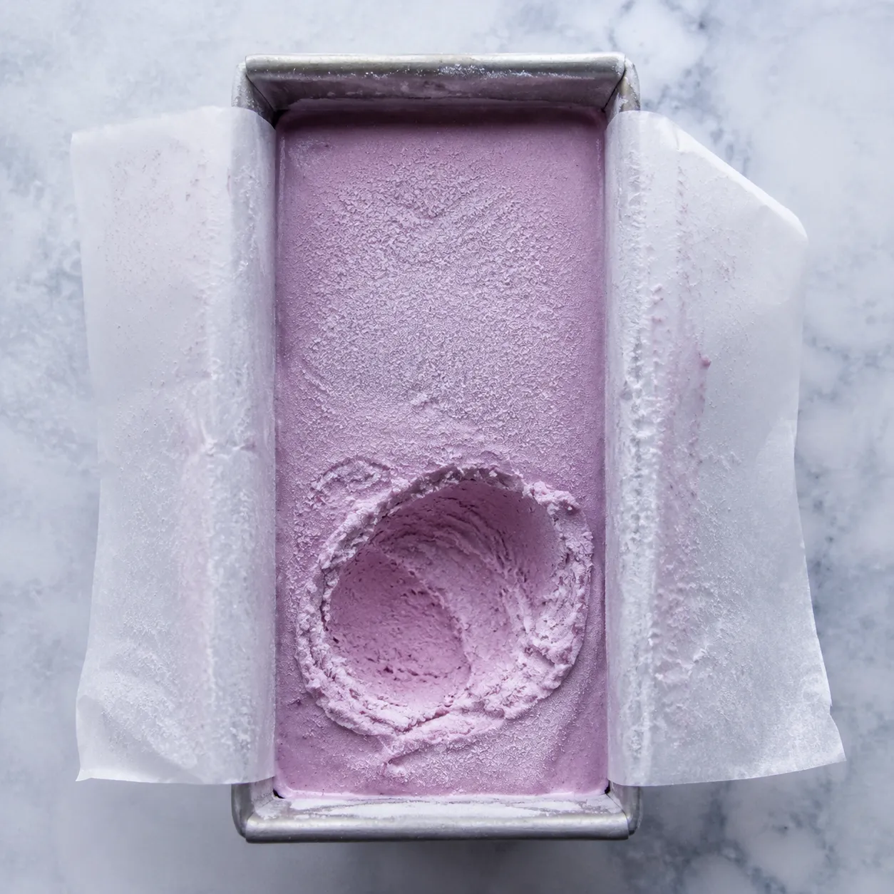 Storing homemade sherbet ice cream in a loaf pan with parchment