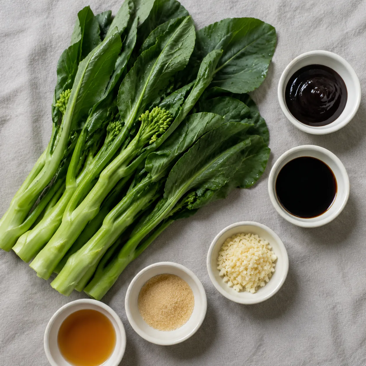 Ingredients for Chinese broccoli recipe including gai lan, garlic, and oyster sauce